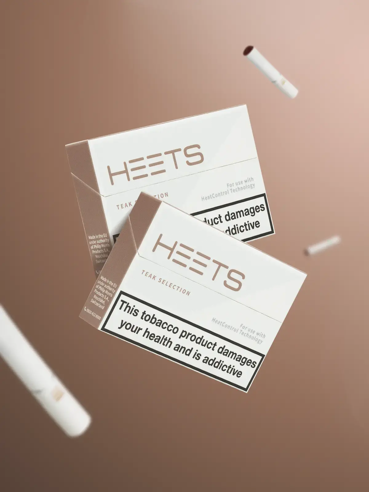 Two packs of IQOS HEETS in Teak flavour floating in front of a light brown background