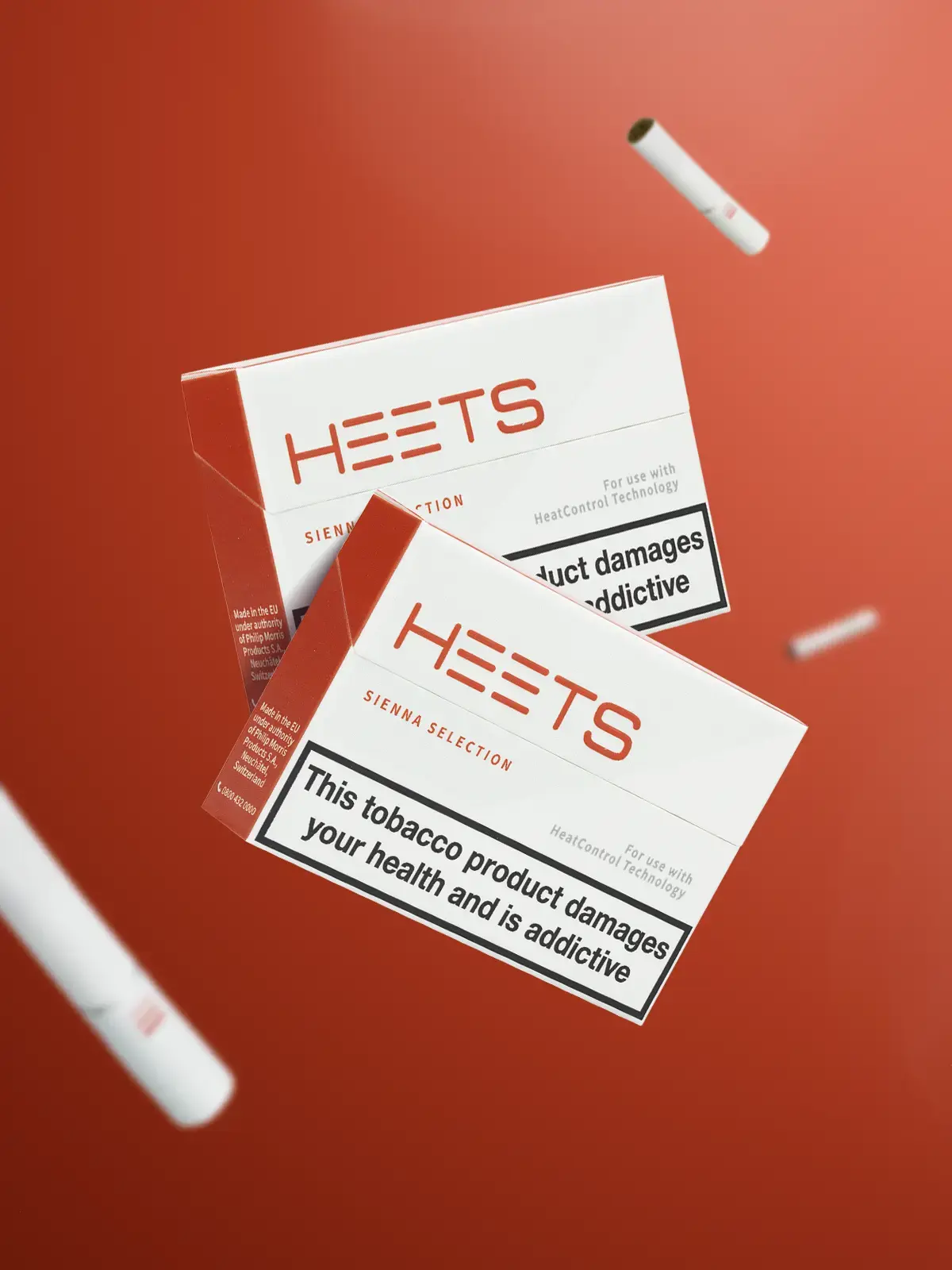 Two packs of IQOS Sienna HEETS floating in front of a red-orange background