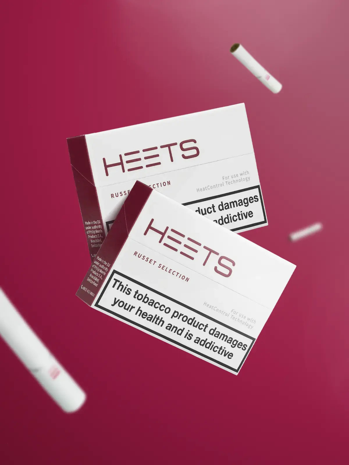 Two packs of IQOS HEETS in Russet flavour, floating in front of a burgandy coloured background