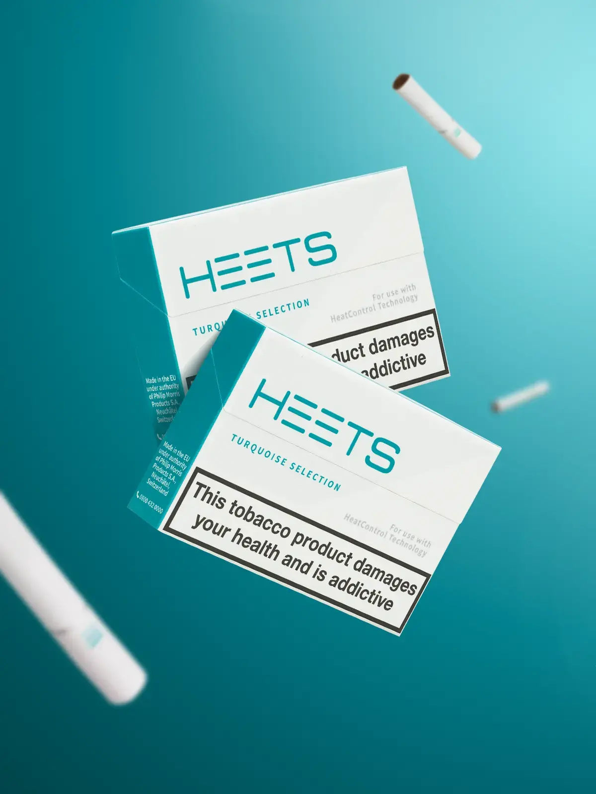 Two packs of IQOS Turquoise HEETS floating in front of turquoise coloured background